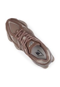 Καφέ αθλητικό παπούτσι τρεξίματος με επάνω μέρος από δίχτυ και συνθετικό υλικό, μαλακή σόλα, υφασματικές λεπτομέρειες και λογότυπο "New Balance" στη γλώσσα και στην εσωτερική σόλα.