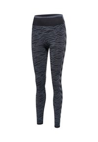 Leggings taille haute noirs et gris foncé avec un motif ondulé rappelant celui d’un zèbre et des rayures en chevrons sur les côtés.