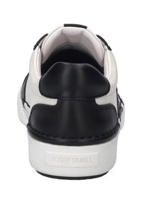 Black and white leather sneaker with a padded collar, textured rubber sole, and contrasting stitching. Features a logo embossed on the heel.