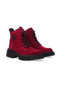 Red suede ankle boots with black laces, a side zipper, and chunky black soles. Features a circular logo on the outer side.
