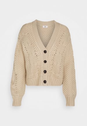 Beige knitted cardigan with a V-neck, featuring cable-knit patterns, long sleeves, and five dark buttons down the front. Cropped fit.