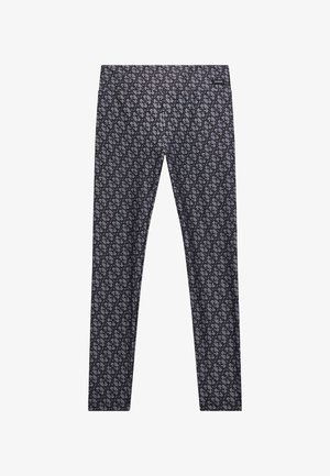 Fekete leggings, amelyek összetett, átfogó, egymásba fonódó formák mintázatával rendelkeznek. Az anyaga sima tapintású és testhezálló fazonú.