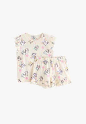 Børnepyjamasæt i cremefarvet med korte ærmer og shorts, med tegneseriefigurer af dyr, regnbuer, hjerter og flæsekant.
