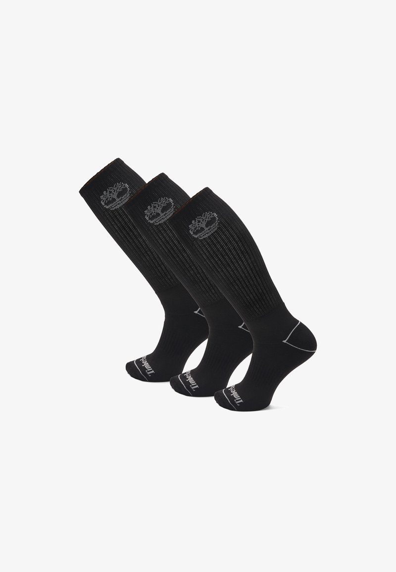 Tre paia di calze nere fino al ginocchio con texture a costine, caratterizzate da un logo e da cuciture bianche a contrasto sulle punte.