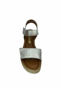 Sandalia de cuero plateada con dos correas anchas, plantilla color marrón y suela contorneada. Presenta una superficie texturizada y un tacón modesto.