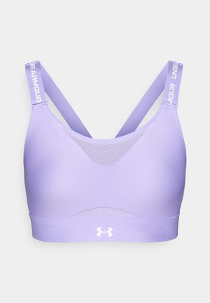 Violet sportinis liemenukas su kryžminėmis petnešomis, tinkliniais detalėmis priekyje ir baltu "Under Armour" logotipu apatinėje juostoje.