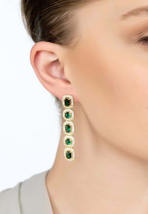 Gold drop earrings with five emerald-cut green gemstones, each framed with clear, sparkling accents, hanging elegantly from the earlobe.