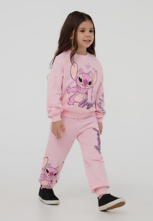 Pantaloni della tuta rosa e felpa coordinata con stampa di personaggi dei cartoni animati e accenti viola, in morbido tessuto e con polsini a costine; adatti per i bambini.