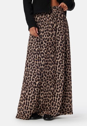 Maxi sukně s leopardím potiskem vyrobená z měkké tkaniny, s elastickým pasem a splývavým designem, v béžových a tmavě hnědých odstínech.