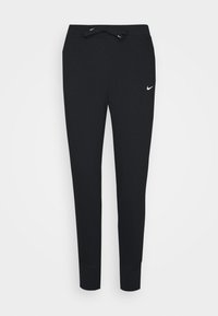 Czarne dresy wykonane z miękkiego materiału, z elastycznym paskiem w talii i małym białym logiem Nike po lewej stronie. Zwężający się krój nogawek.