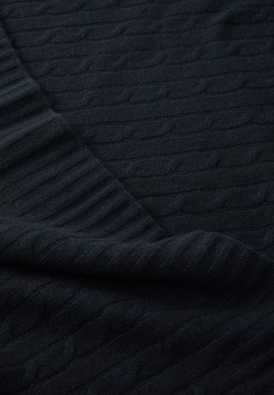 Black knitted fabric with a textured cable pattern and ribbed edges, showcasing a soft, cozy appearance and thickness.