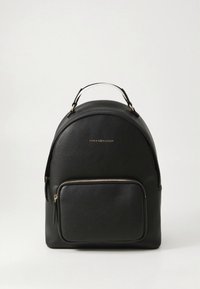 Black leather backpack with rounded shape, front zip pocket, top handle, and gold hardware accents. Features logo on the front.
