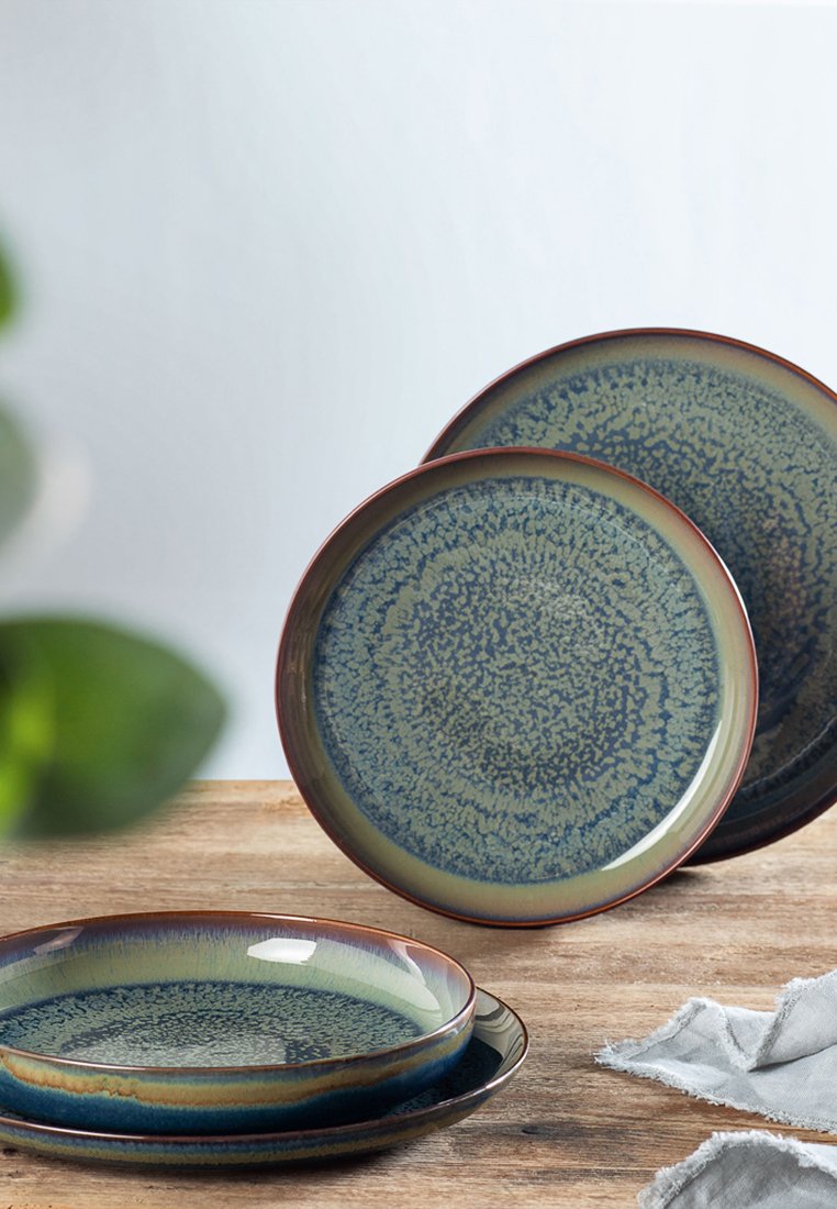 Set aus drei Keramiktellern mit einer gesprenkelten blauen und grünen Glasur, glänzender Oberfläche und kontrastierenden dunklen Randdetails.