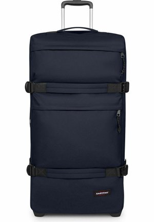 Marineblauer Trolley mit ausziehbarem Griff, zwei schwarzen Kompressionsriemen, vorderen Reißverschlusstaschen und Eastpak-Logo unten rechts.