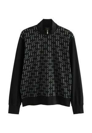 Sudadera con cremallera en negro y gris que presenta un patrón geométrico texturizado en el frente y mangas largas completamente negras. Material suave, ajuste relajado.