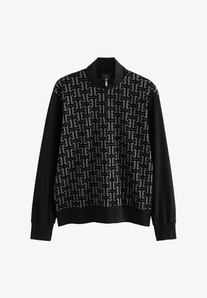 Sort og grå lynlås sweatshirt med et tekstureret geometrisk mønster på fronten og ensfarvede sorte lange ærmer. Blødt materiale, afslappet pasform.