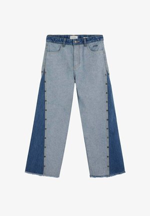 Tweedekleurige spijkerbroek met een lichtere voorkant en donkerdere zijpanelen, drukknoopdetails langs de buitenste naden, vijfzakkenmodel en onafgewerkte zoomranden.