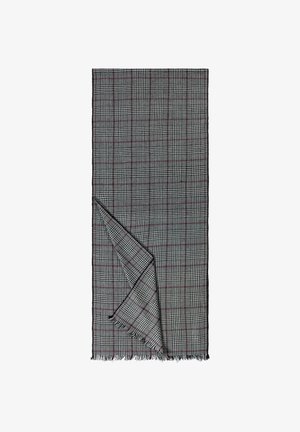 Woven blanket in black, white, and red check pattern. Features fringed edges and a soft texture, folded partially to show dual sides.