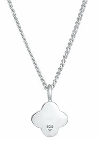 Silver necklace with a twisted chain and a four-leaf clover pendant. Pendant marked "925," indicating sterling silver. Smooth texture.