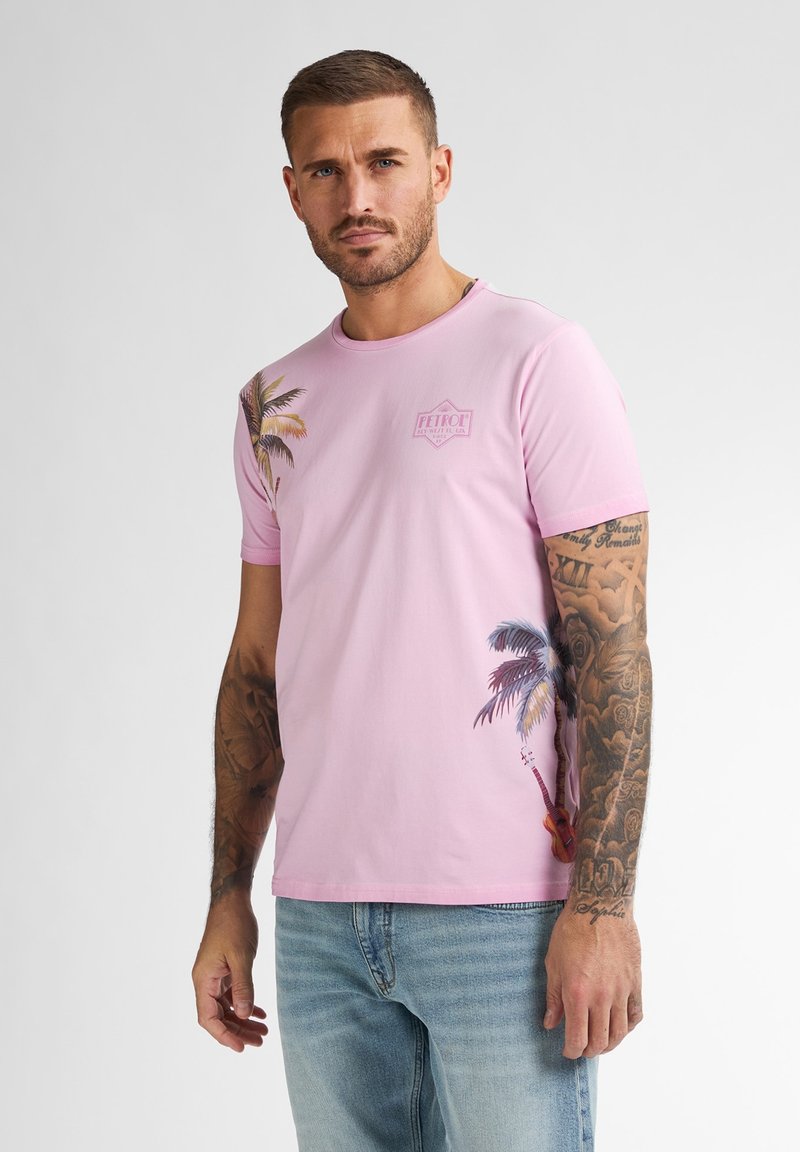 Camiseta de manga corta rosa con gráficos de palmera en el hombro izquierdo y el costado, hecha de suave tela de algodón.