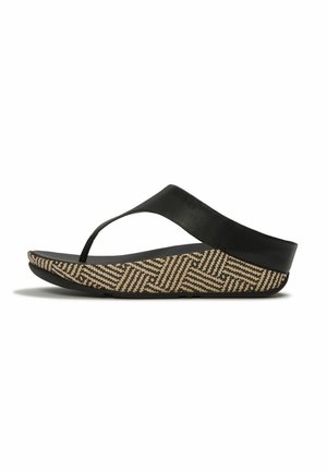 Black wedge sandal with wide strap and toe post, featuring a patterned beige and black textured sole.