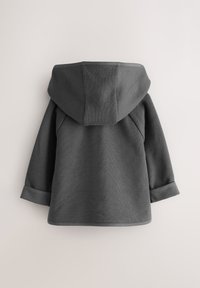 Gray hoodie made of textured fabric with a hood, featuring rolled cuffs and a straight hem. Visible seams and structured design details.