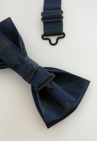 Navyblaues Karomuster-Fliege aus strukturiertem Stoff, ausgestattet mit einem schwarzen Hardware-Verschluss. Enthält ein verstellbares Band mit einem ähnlichen Design.