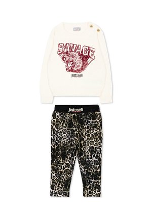 Biały sweter z grafiką "SAVAGE" i ryczącym leopardem, połączony z spodniami w zwierzęcy wzór z czarnym paskiem w talii "Just Cavalli".