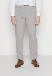 Light gray tailored trousers with a subtle texture, featuring belt loops and a slim fit, paired with brown leather dress shoes.