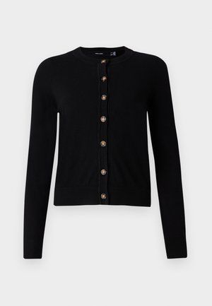 Musta pitkähihainen neuletakki, jossa on pyöreä pääntie ja kahdeksan ruskeaa nappia edessä, ribbireunat hihoissa ja helmassa.