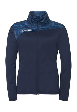 Marineblauw volledig met rits sluitend jack met geometrisch patroon op het bovenstuk in donkerder blauw, hoge kraag, lange mouwen, en wit "Kempa" logo op de borst.