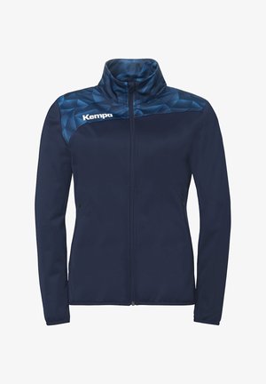 Marineblauw volledig met rits sluitend jack met geometrisch patroon op het bovenstuk in donkerder blauw, hoge kraag, lange mouwen, en wit "Kempa" logo op de borst.