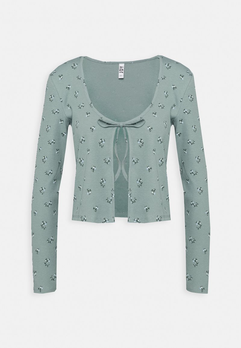 Cardigan court vert clair à manches longues, imprimé floral blanc délicat et fermeture à nouer à l'avant sous un décolleté en U.
