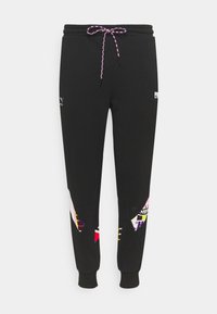 Sorte joggingbukser med elastisk talje og en flerfarvet mønstret detalje på siderne. Snor med en tekstureret, flettet design.