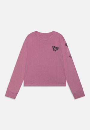 Langærmet mauve cropped skjorte med sort blomsterdesign på brystet og grafiske tryk langs højre ærme.