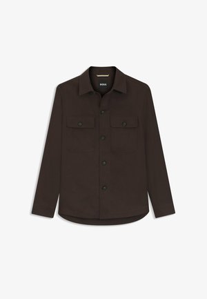 Dark brown button-up shirt with two front flap pockets and long sleeves, featuring a classic collar and a slightly curved hem.