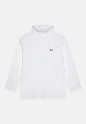 Maglione a collo alto bianco a maniche lunghe realizzato in tessuto morbido, con un piccolo logo verde Lacoste sul lato sinistro del petto.