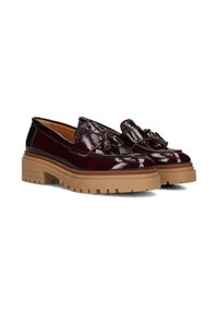 Burgundy patent leather shoes with a decorative tassel, featuring a chunky tan rubber sole and rounded toe design.