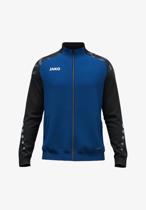 Blauw-zwarte sportjas met ritssluiting en JAKO-logo op de borst, patroon op de schouders en kleine stippen op de zwarte mouwen.