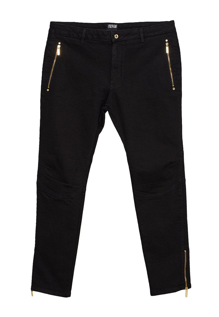 Zwarte slanke broek met gouden ritssluitingen op de heupen en ritssluitingen bij de enkels, knoopsluiting en riemlussen.