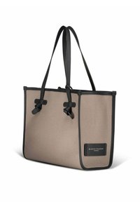 Borsa tote in tela beige con finiture e spalline in pelle nera, caratterizzata da due nodi decorativi e una toppa con logo laterale.