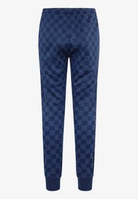 Marineblå sweatpants lavet af blødt stof, med et helt gennemgående geometrisk mønster og elastiske smocks ved anklerne.