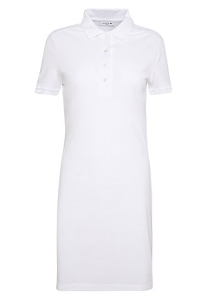 Robe polo blanche en coton, dotée d'un col, de manches courtes, d'une patte de boutonnage à cinq boutons et du logo Lacoste sur la poitrine.