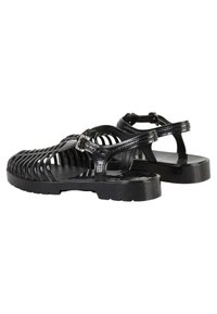 Sandali neri in plastica testurizzata, con un design intrecciato e fibbia regolabile, dotati di una robusta suola in gomma nera.