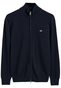 Gilet zippé bleu marine en tissu tricoté, col et poignets côtelés, avec un petit logo sur la poitrine gauche, texture lisse, coupe classique.