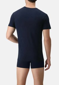 T-shirt in cotone blu navy con maniche corte, mostrato da dietro, abbinato a boxer shorts blu navy coordinati. Tessuto morbido, design aderente.