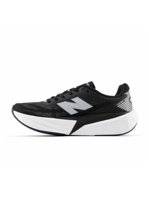 Black and white New Balance running shoe with thick sole, mesh upper, and "N" logo on the side, viewed from the outer side.