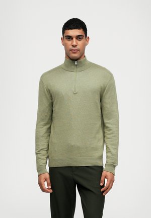 Lichtgroene pullover met hoge kraag en een ritssluiting aan de voorkant. Gemaakt van een zachte stof, met ribgebreide manchetten en zoom.