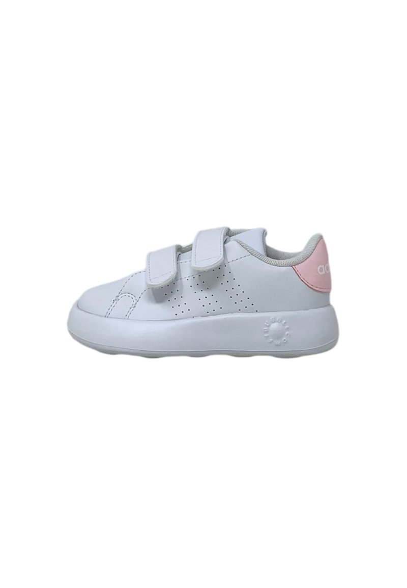 White synthetic sneaker with two Velcro straps, perforated side design, light pink heel accent, and a cushioned sole.
