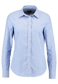 Camicia azzurro chiaro a maniche lunghe, realizzata in cotone, con un motivo a pois, colletto classico e orlo curvo.